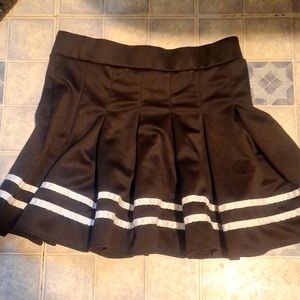 Black pleated skirt with 2 white strips on the bottom